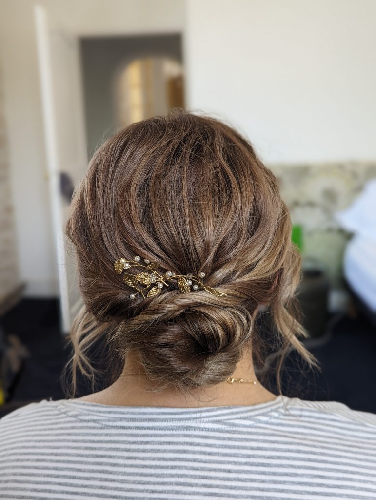 Photo of Bride from behind showing professional hair and makeup by Bristol makeup artist Evie Smith.